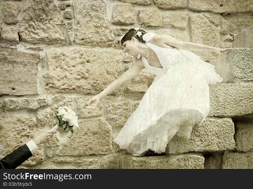 Vintage photo of bride reaching for her bouquet