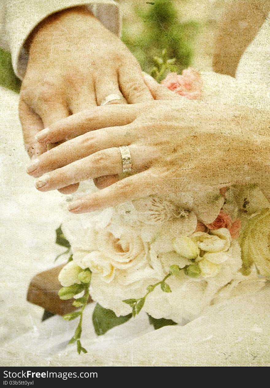 Vintage photo of hands and rings on wedding bouquet