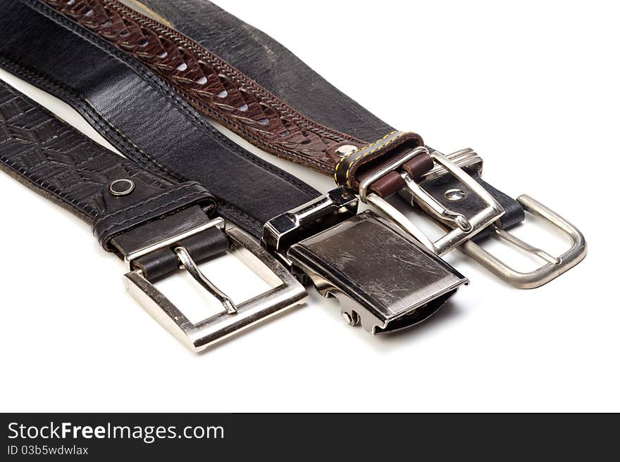 Old leather belts are isolated on a white background