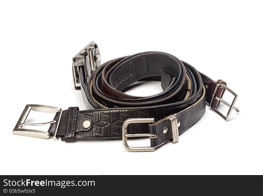 Old leather belts are isolated on a white background