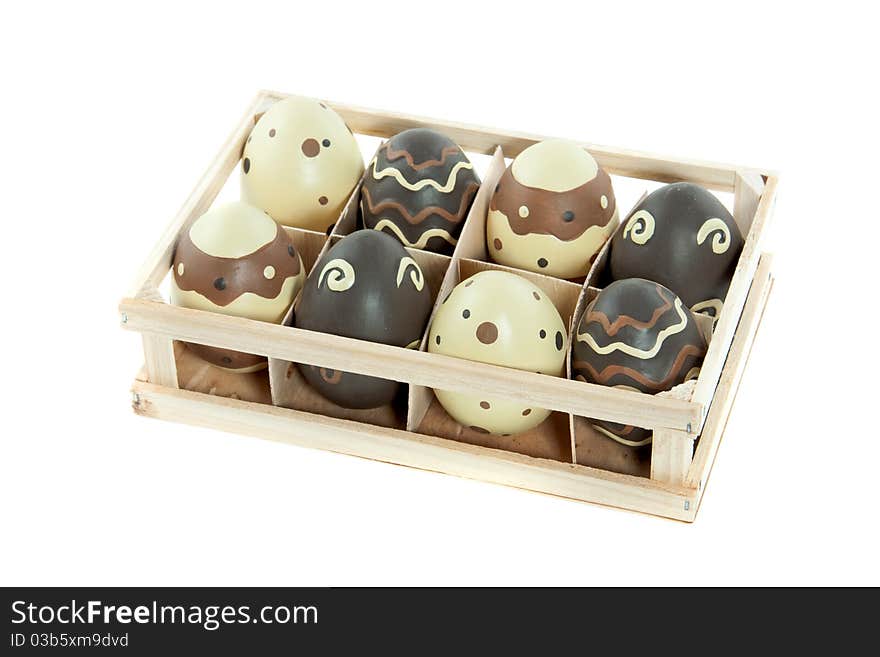 Eight painted easter eggs in a wooden tray isolated over white background