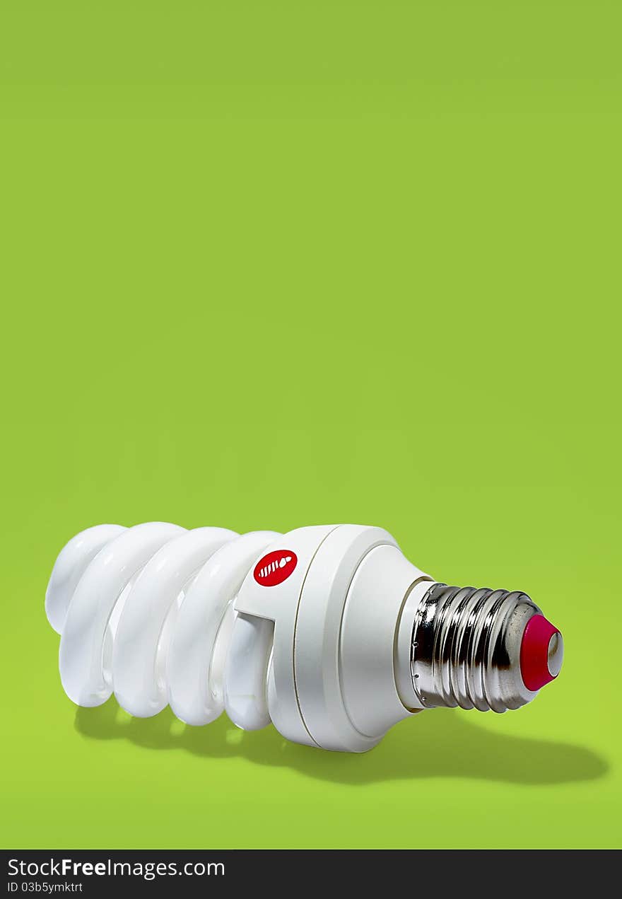 Electric energy saving light bulbs on a green background. Electric energy saving light bulbs on a green background.