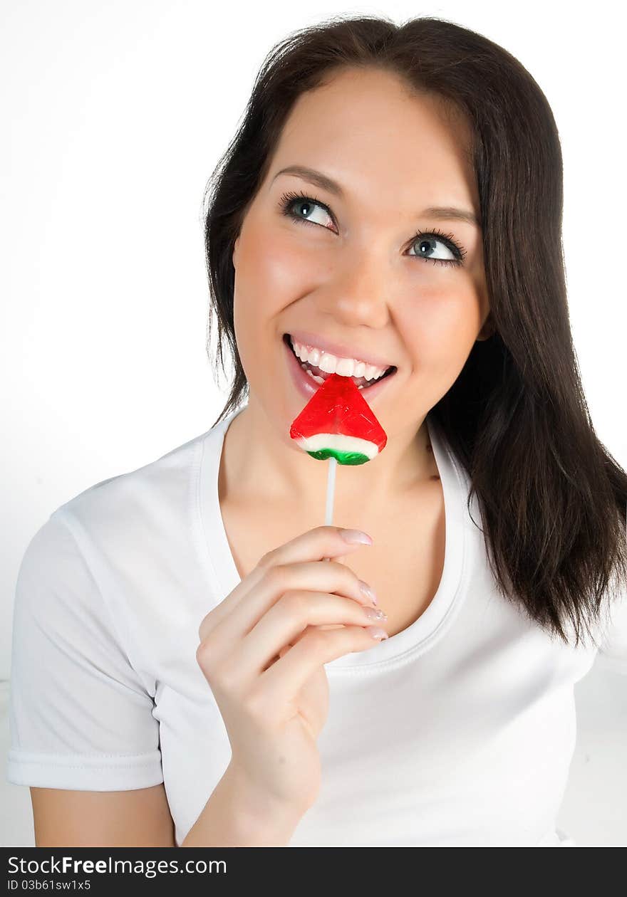 Pretty girl with candy on a white background