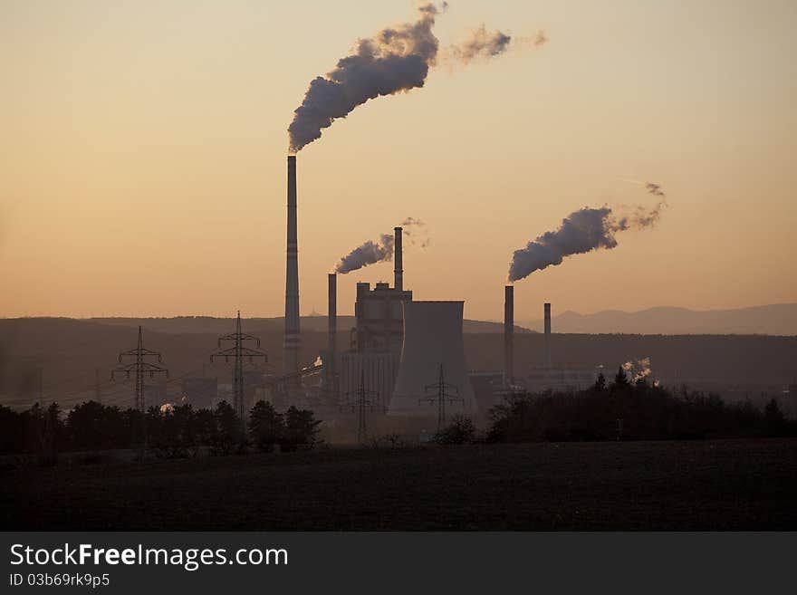 Power plant in sunset, smoking, ecology