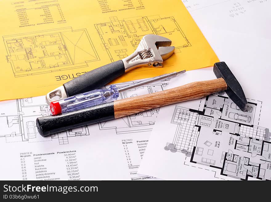 Tools on Blueprints including hammer, screw driver and monkey wrench.
House plans printed on white and yellow paper. Tools on Blueprints including hammer, screw driver and monkey wrench.
House plans printed on white and yellow paper