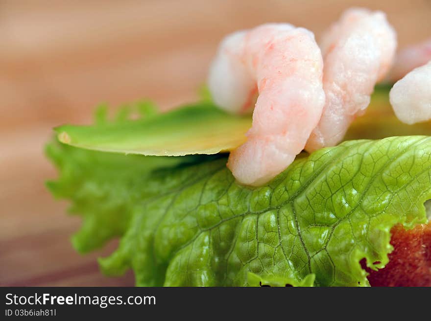 Sandwich garnish with shrimps, avokado and lettuce on  bamboo napkin, snack. Sandwich garnish with shrimps, avokado and lettuce on  bamboo napkin, snack