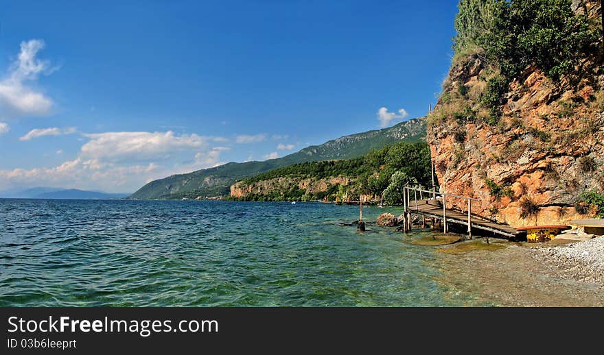 Boulder rock beach with bridge in sunny day with blue sky. Boulder rock beach with bridge in sunny day with blue sky