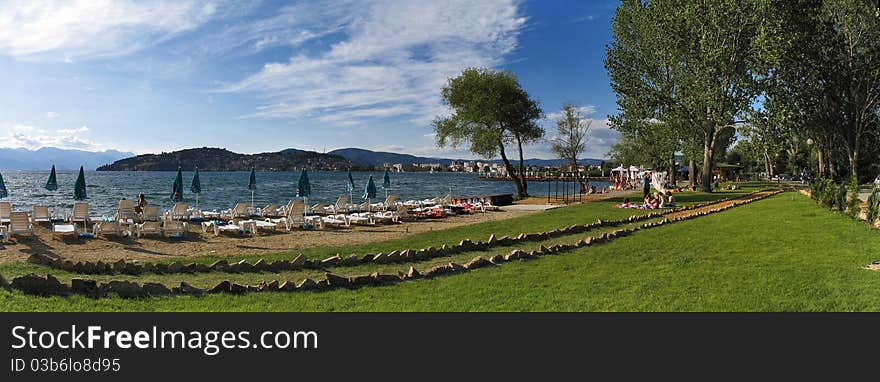 Sand beach  in sunny day with blue sky and green grass. Sand beach  in sunny day with blue sky and green grass