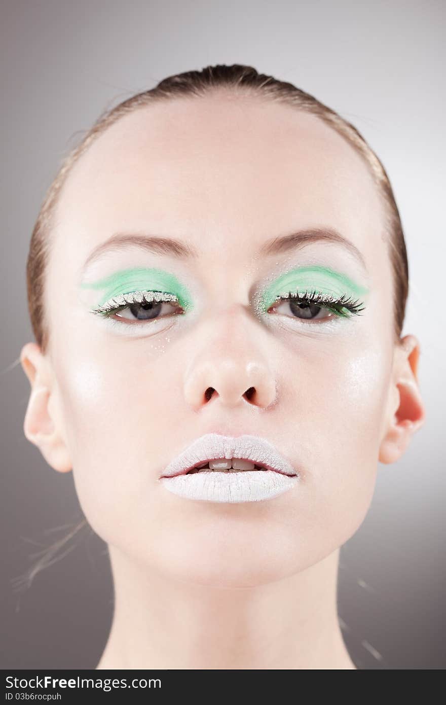 Confident beautiful woman portrait with unusual green-white make-up. Confident beautiful woman portrait with unusual green-white make-up