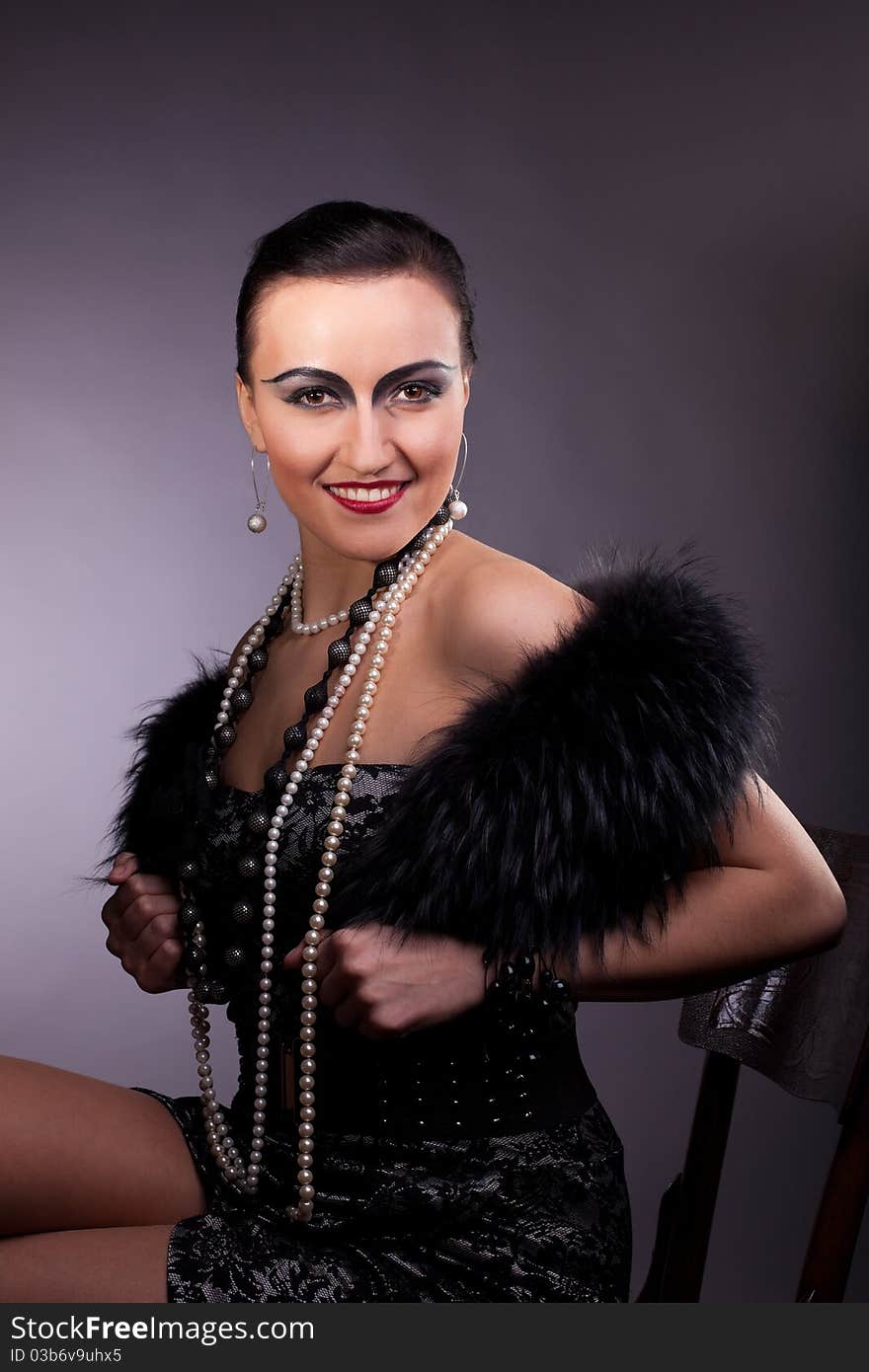 Proud woman smile in fur boa with pearl beads