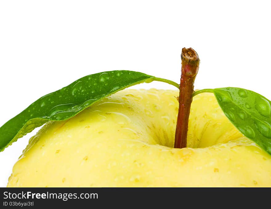 Fresh yellow apple with leaf. Isolated on white background.