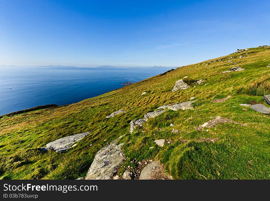 cliff by sea under blue sky , Ireland