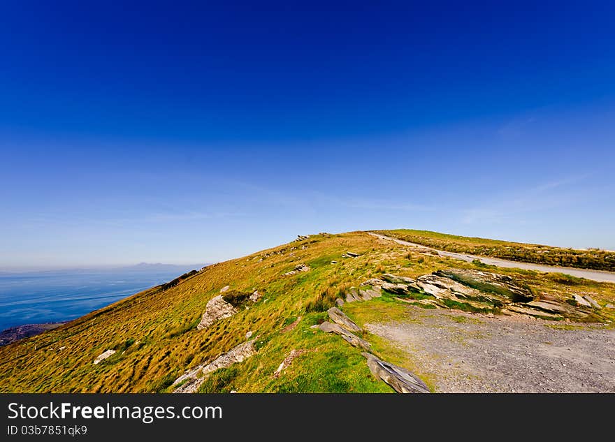 Cliff over sea under blue sky, Valencia Island, Ireland. Cliff over sea under blue sky, Valencia Island, Ireland