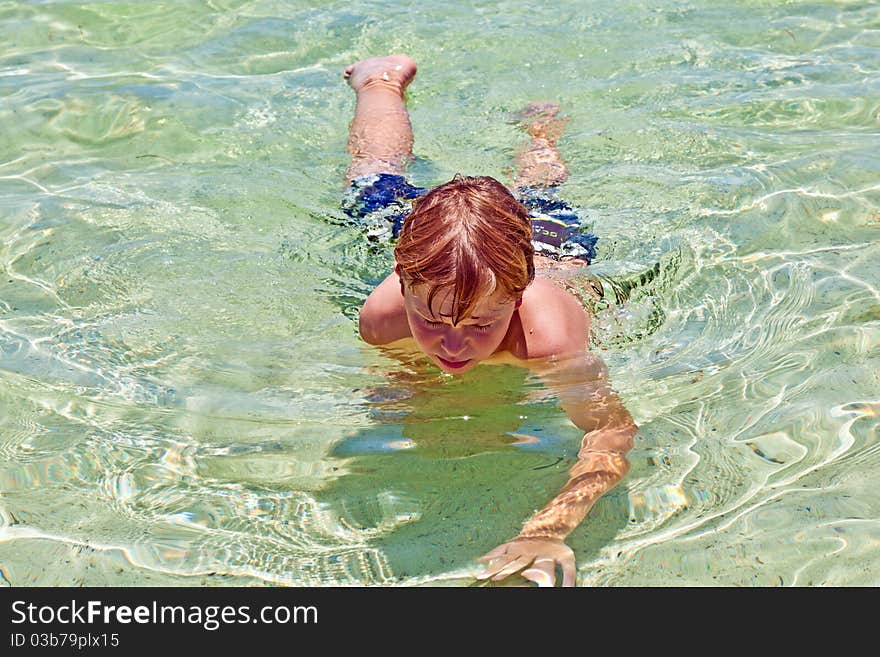 Boy has fun in the clear  ocean