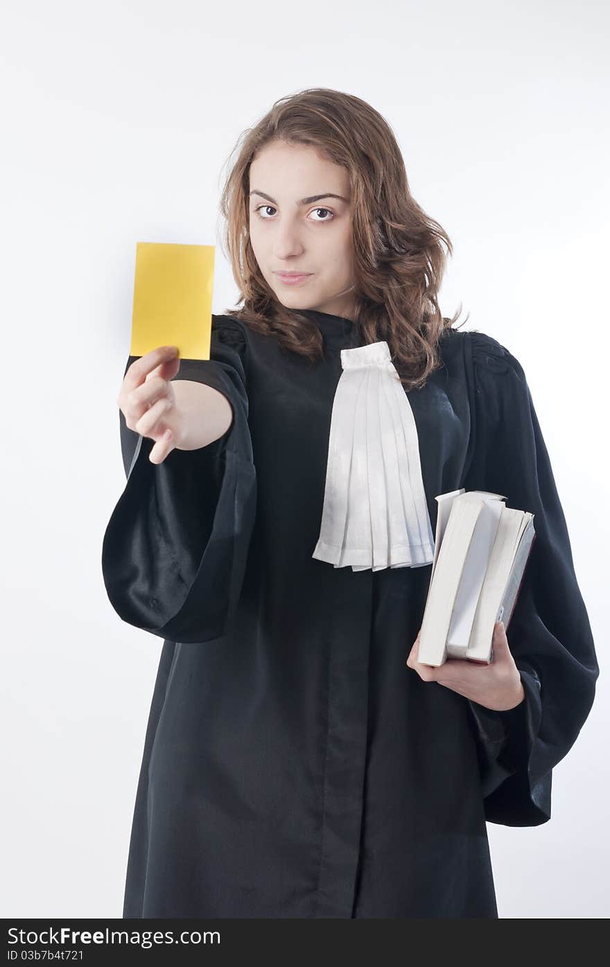 Young law school student showing a yellow card. Young law school student showing a yellow card