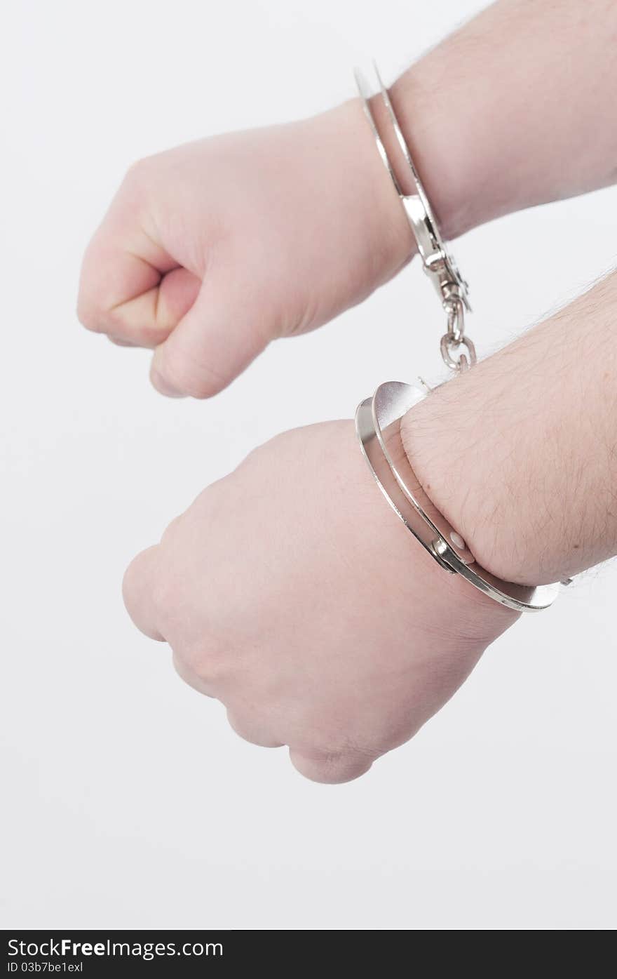 Handcuffed adult man hands; shooted in studio. Handcuffed adult man hands; shooted in studio