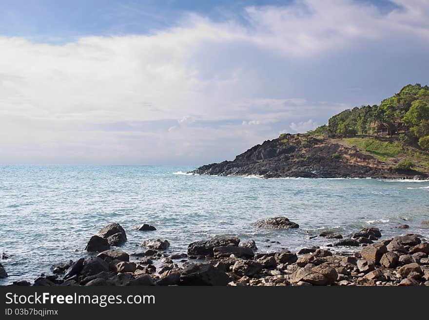 Stony shore, clear water. Stormy couds approaching. Stony shore, clear water. Stormy couds approaching.