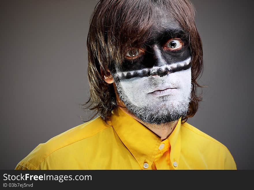 Portrait of a painted young man in studio. Portrait of a painted young man in studio