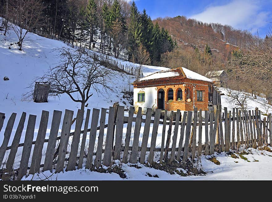 Wooden fence household in sunny winter time