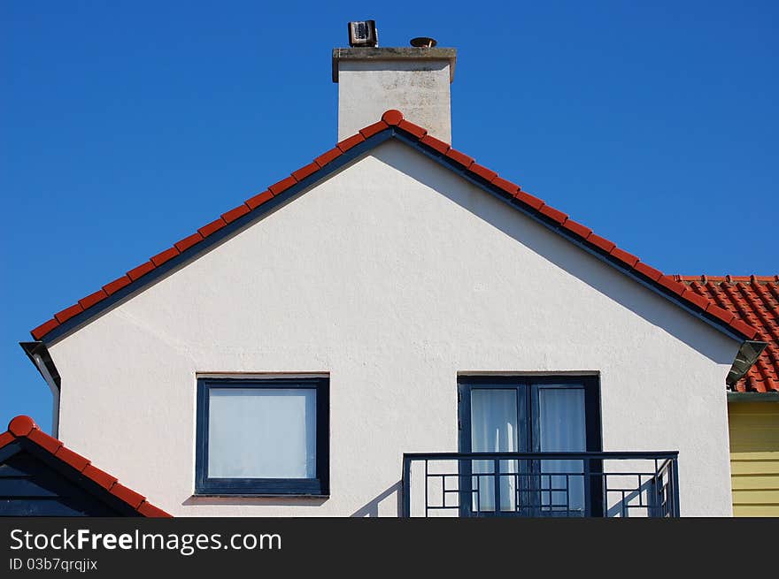 A white house with a blue sky. A white house with a blue sky