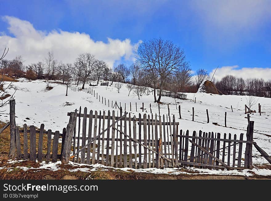 Wooden fence household in sunny winter time. Wooden fence household in sunny winter time