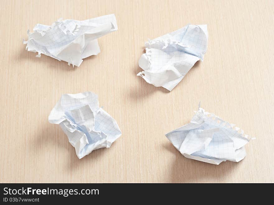 Ripped white paper on wooden desk. Ripped white paper on wooden desk