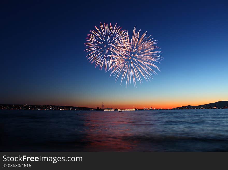 Two fireworks bursting at twilight. Two fireworks bursting at twilight.