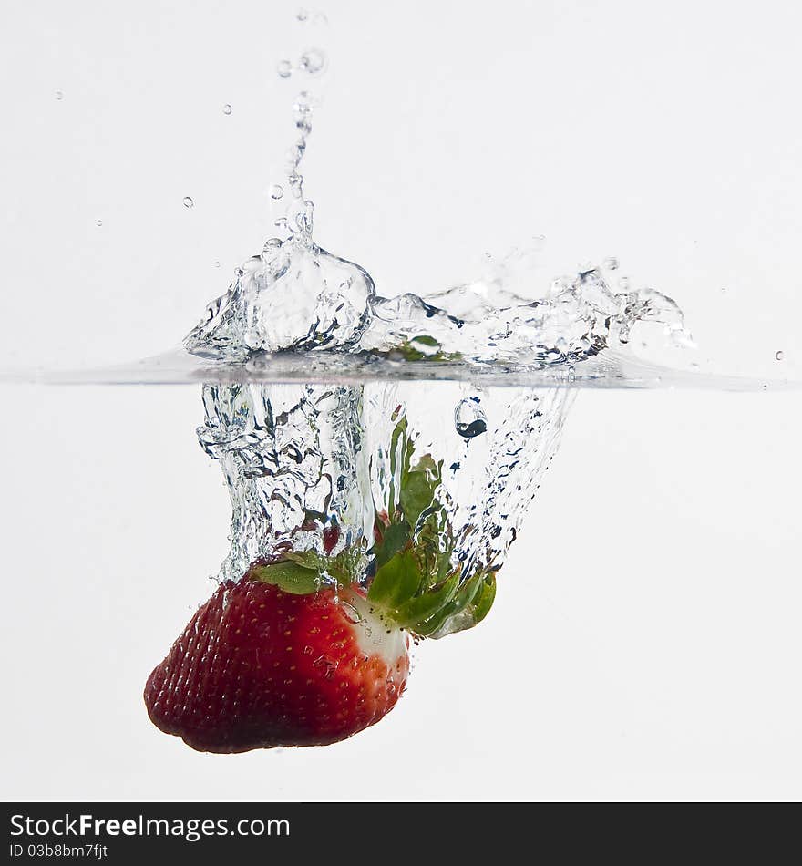 The strawberries dropped into water. The strawberries dropped into water