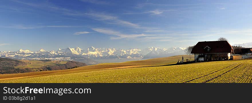 Swiss alps with farmhouse seen from Zimmerwald