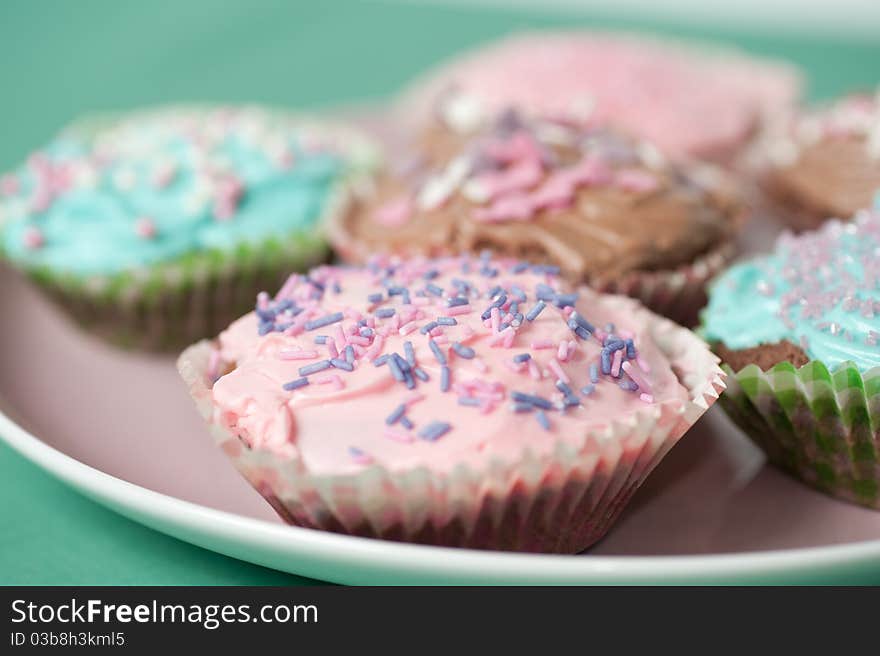 Homemade cupcakes with frosting on a pastell table