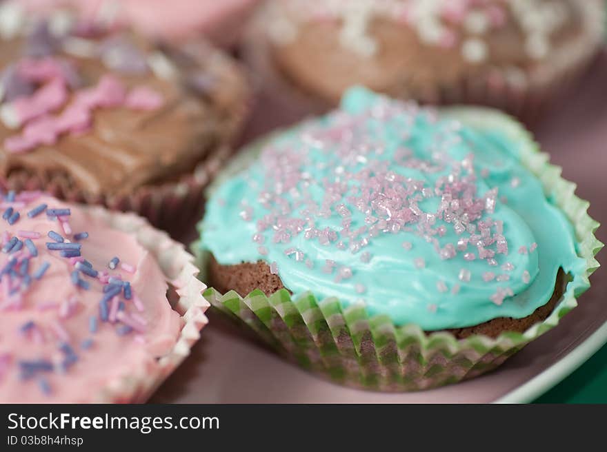 Homemade cupcakes with frosting on a pastell table