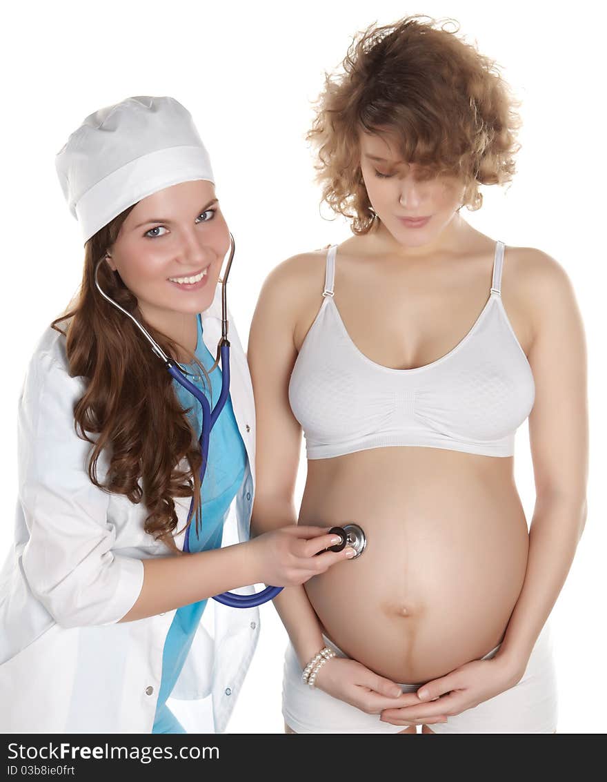 Studio photography of a doctor checks the abdomen and heardbeat of pregnant women isolated on white backgroud. Studio photography of a doctor checks the abdomen and heardbeat of pregnant women isolated on white backgroud