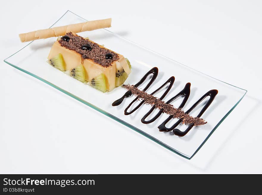 Custard with kiwi pieces, rolled wafer and chocolate. Custard with kiwi pieces, rolled wafer and chocolate