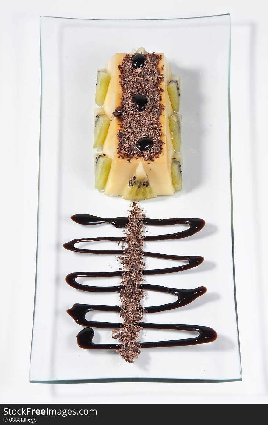 Custard with kiwi pieces, rolled wafer and chocolate. Custard with kiwi pieces, rolled wafer and chocolate