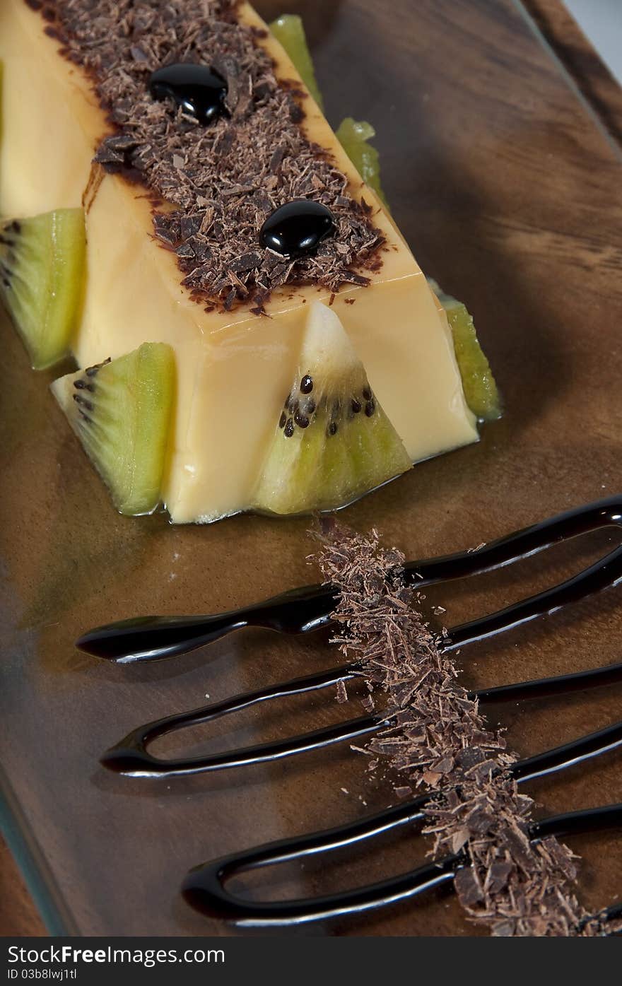 Custard with kiwi pieces, rolled wafer and chocolate. Custard with kiwi pieces, rolled wafer and chocolate