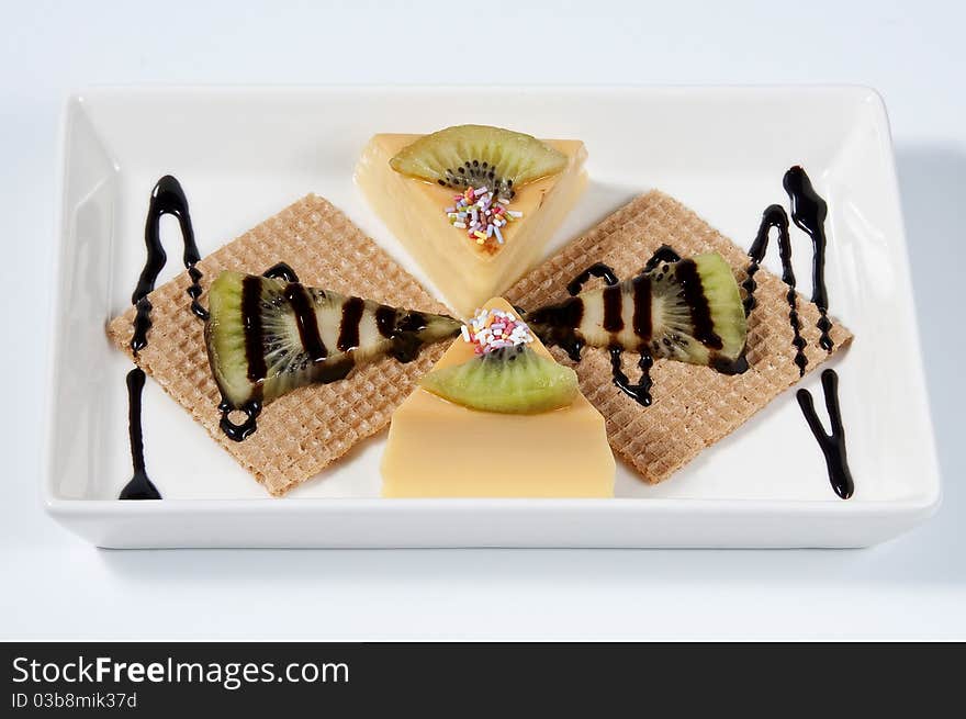 Custard with kiwi pieces, rolled wafer and chocolate. Custard with kiwi pieces, rolled wafer and chocolate