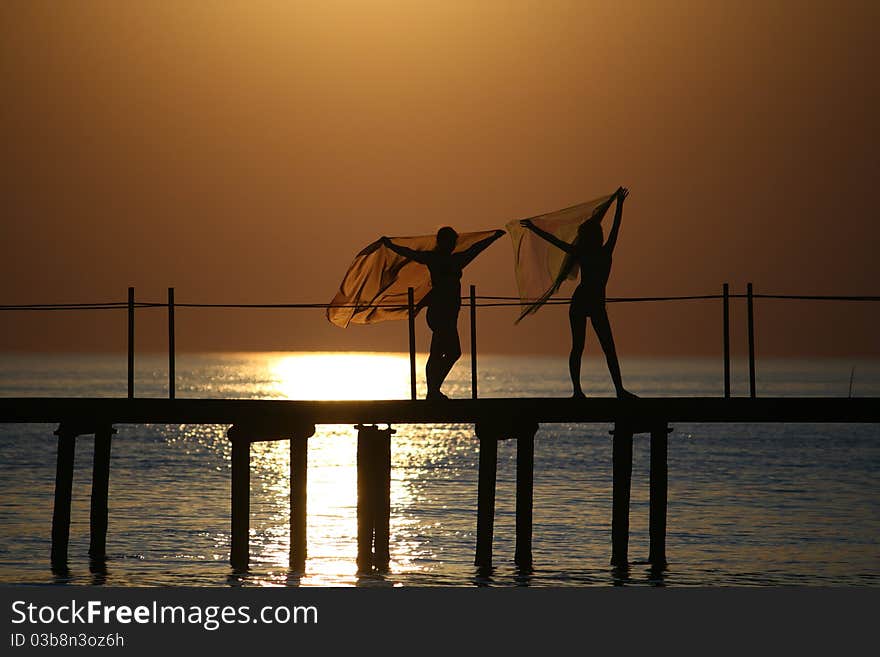 Girls On A Bridge At Sunset.