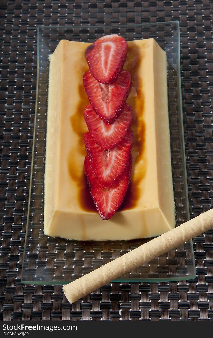 Custard picture with strawberries and rolled wafers. Custard picture with strawberries and rolled wafers