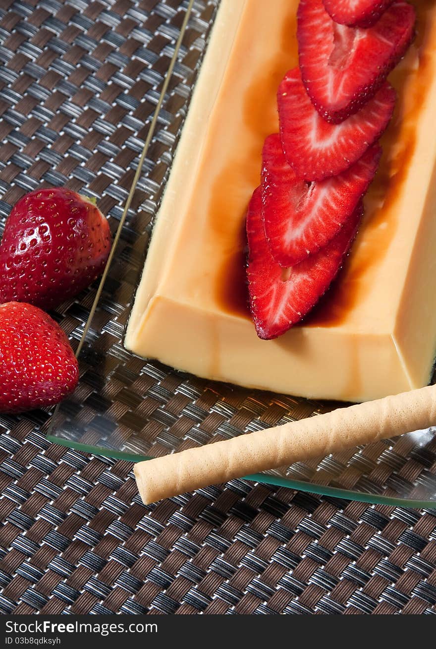 Custard picture with strawberries and rolled wafers. Custard picture with strawberries and rolled wafers