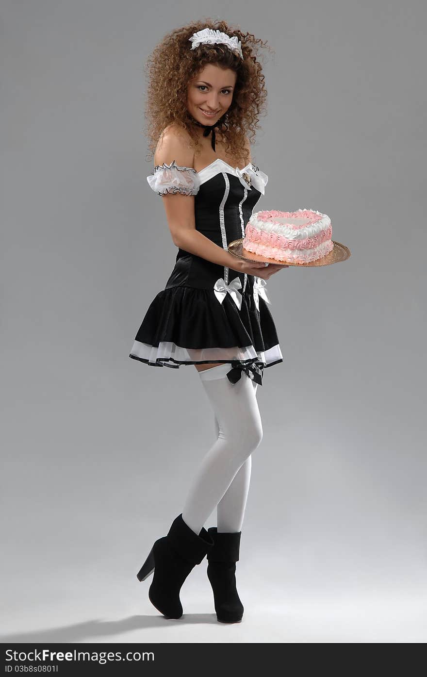 Woman Waiter Holding A Tray Of Cake