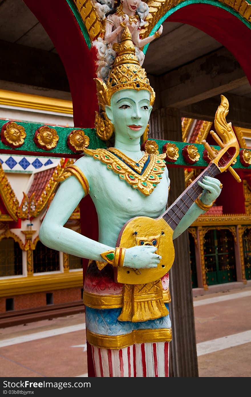 Crying fairy string player stucco in Thai traditional art and craftsmanship at a rural Thai temple.