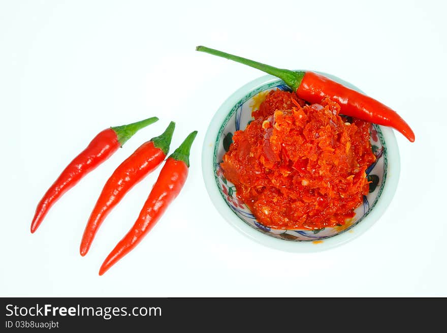 A Small Saucer Of Freshly Ground Chili And Some Red Chili Pepper. A Small Saucer Of Freshly Ground Chili And Some Red Chili Pepper