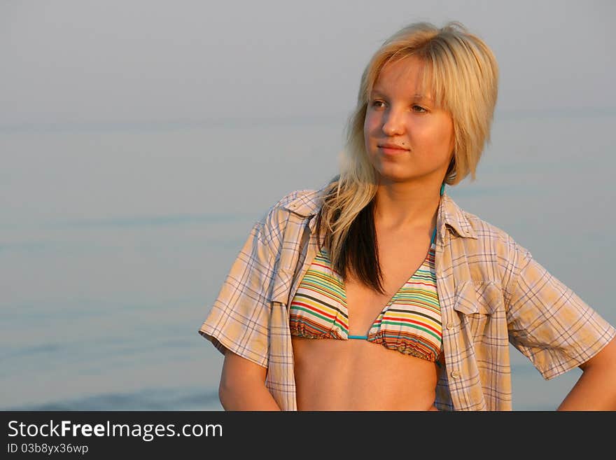 Girl posing. Water on background