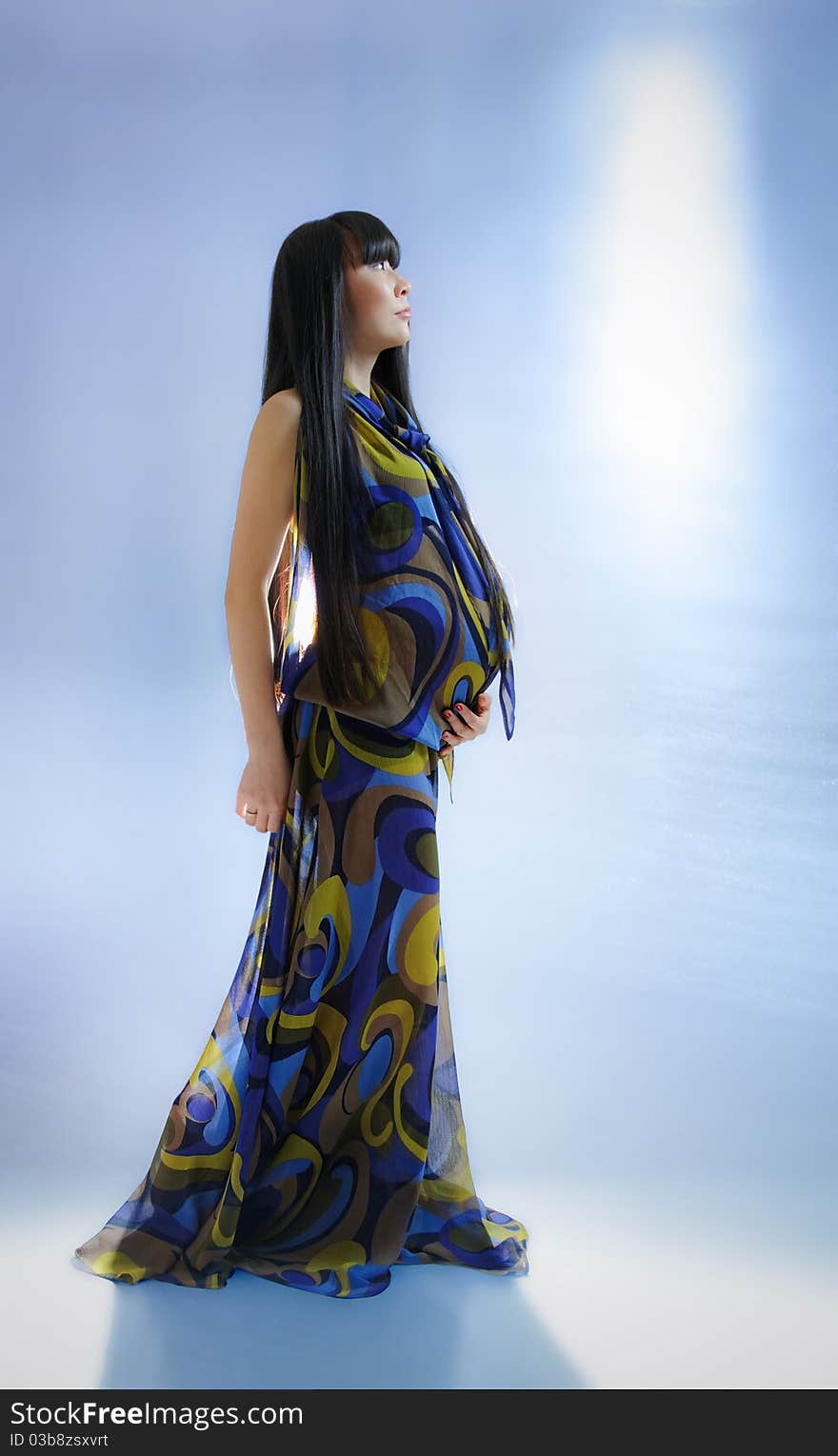 Asian pregnant woman in transparent dress on blue background with radiance. Asian pregnant woman in transparent dress on blue background with radiance