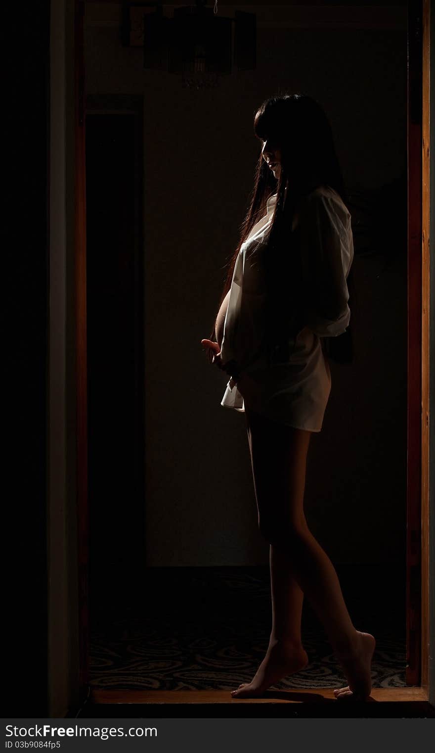 Asian pregnant woman in the dark room. Asian pregnant woman in the dark room