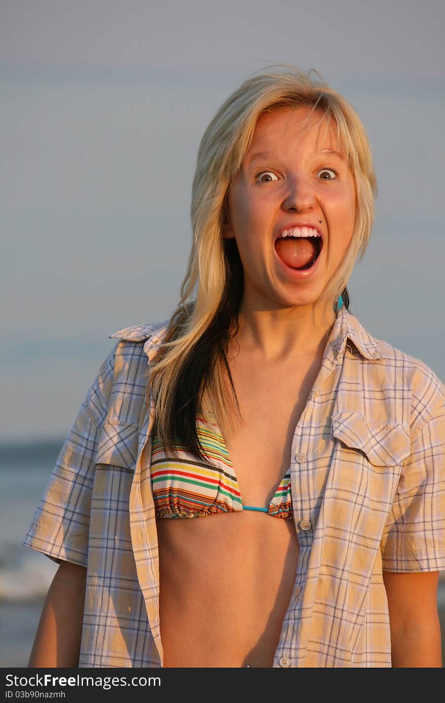 Girl cries with water at background. Girl cries with water at background.