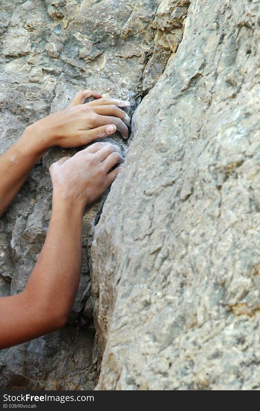 Climbers hands on the rock