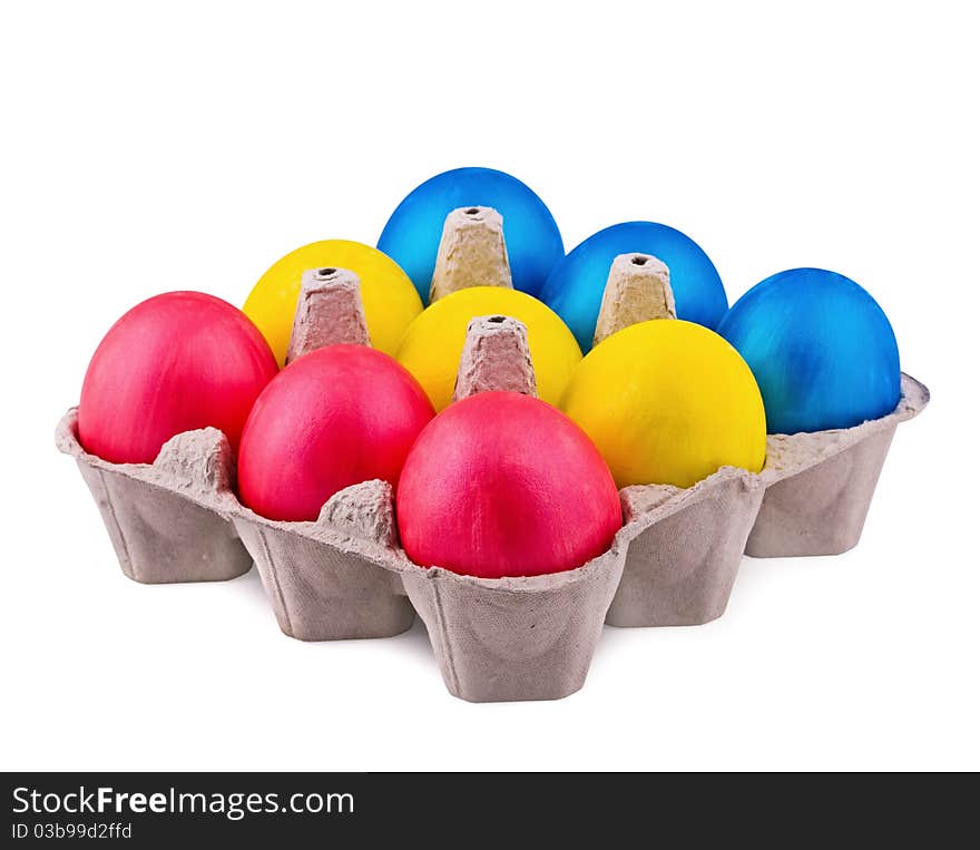 Bright multi-colored eggs in cells on a white background