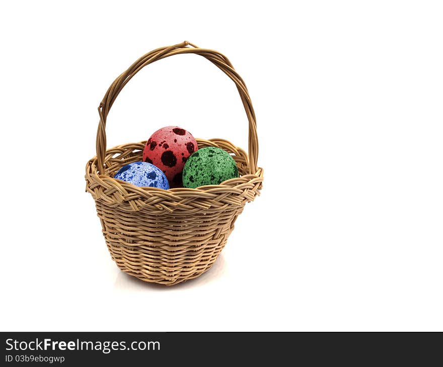 Three coloured quail eggs in a basket. Three coloured quail eggs in a basket