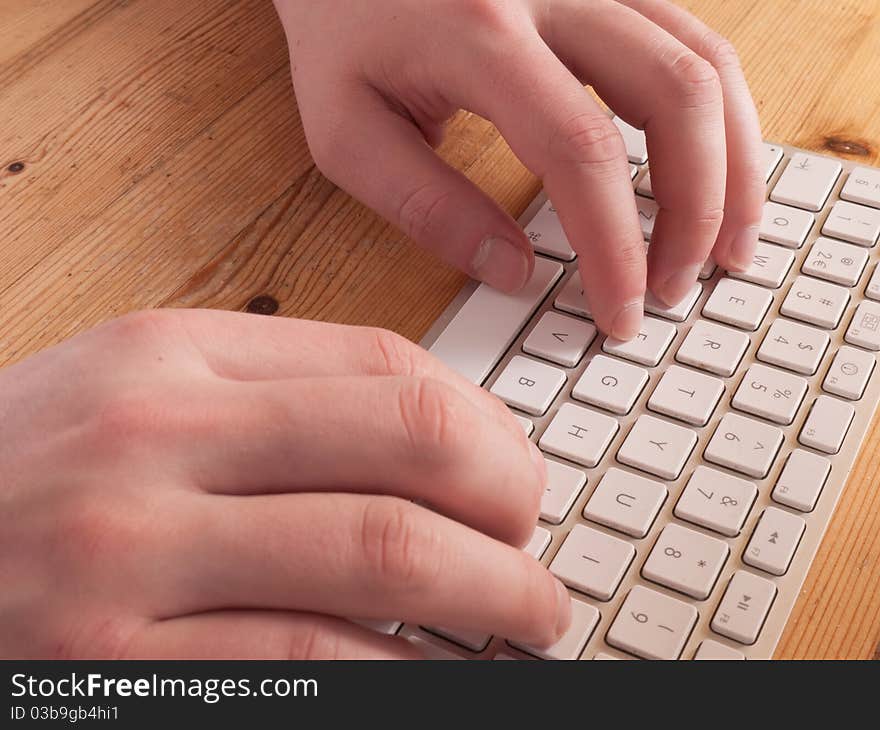 Man typing on a computer keyboard. Man typing on a computer keyboard